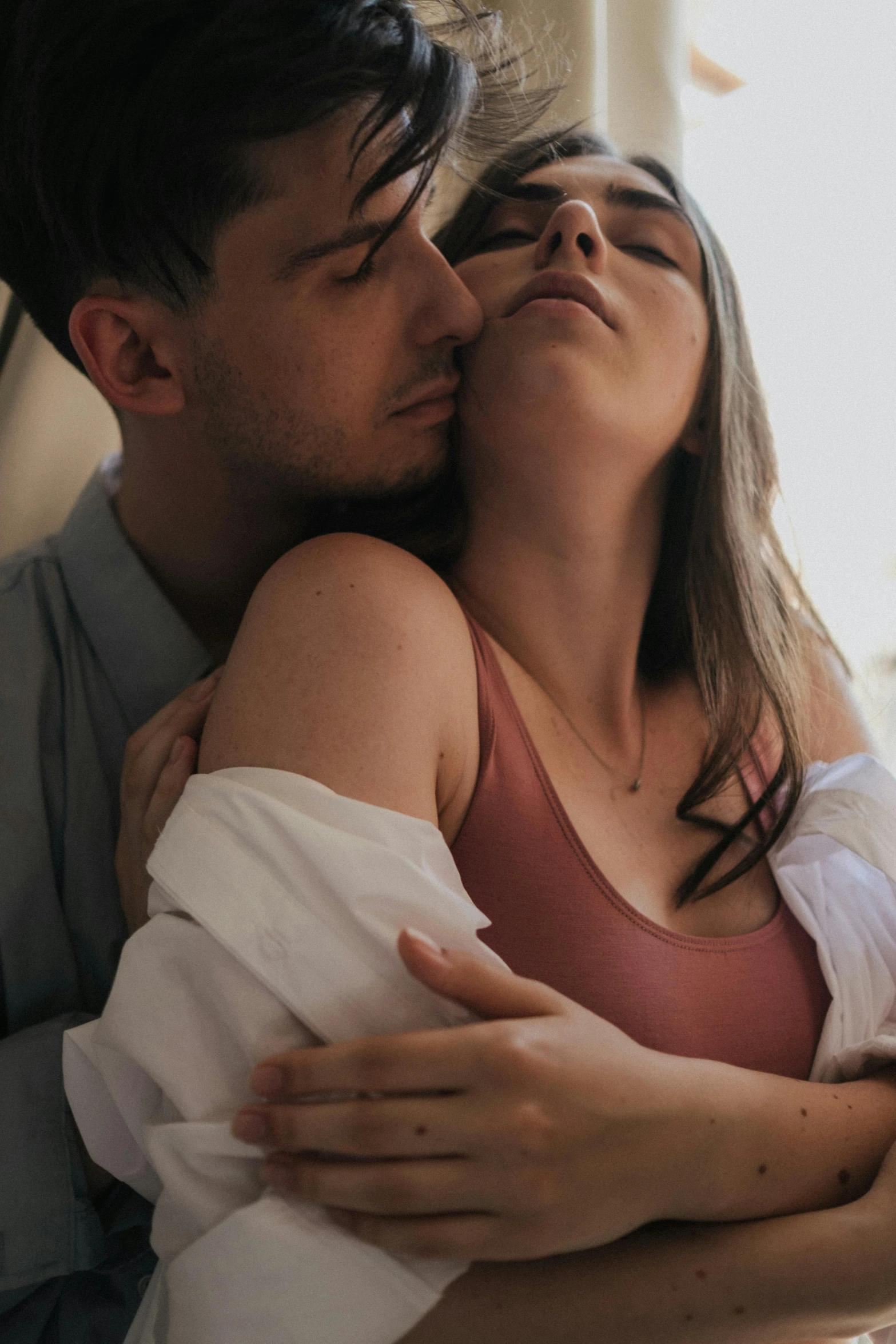 a man and woman kissing each other in bed