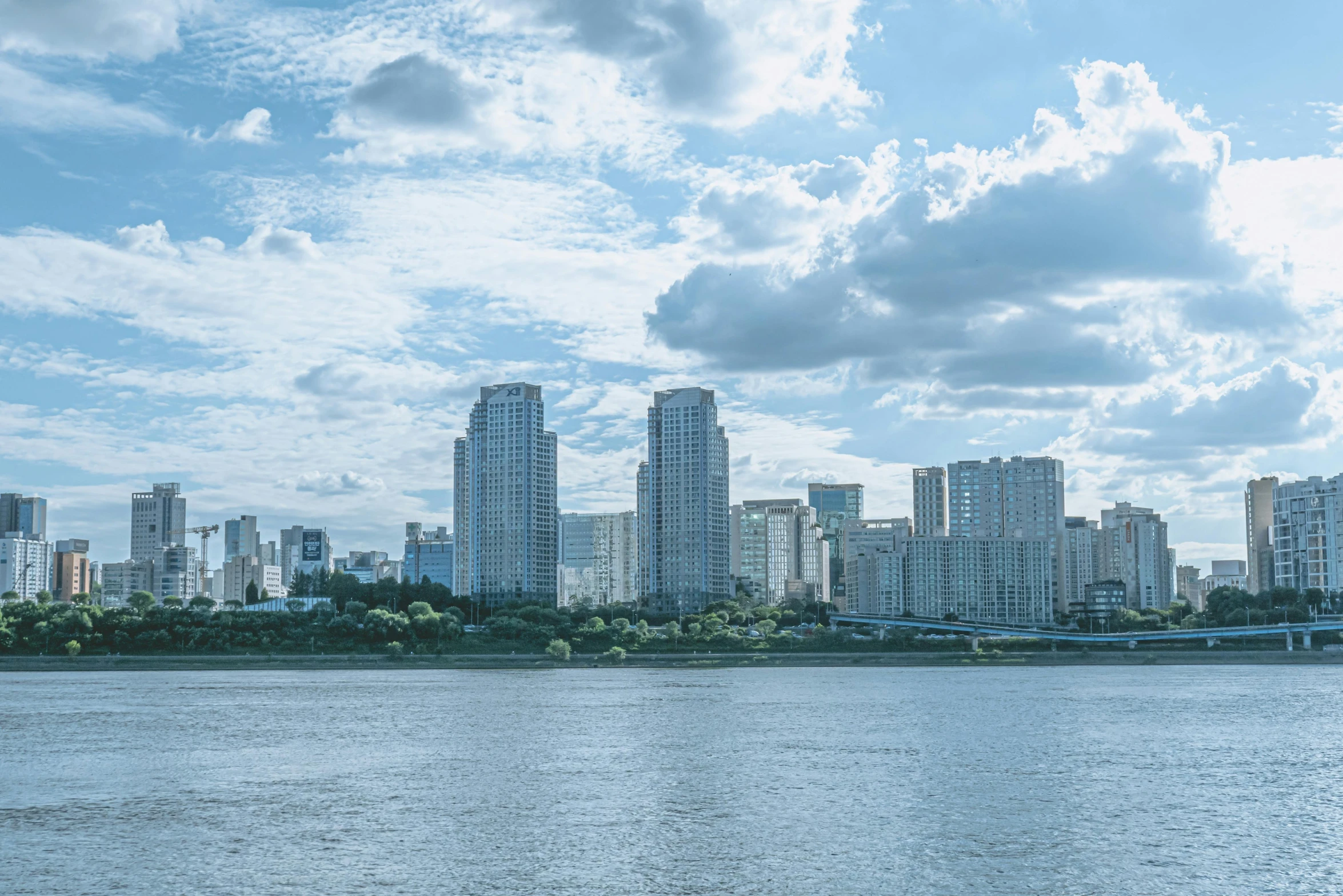 a city sits on a bank above a lake