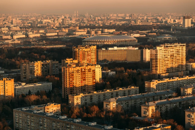 the sun sets on tall buildings in a city