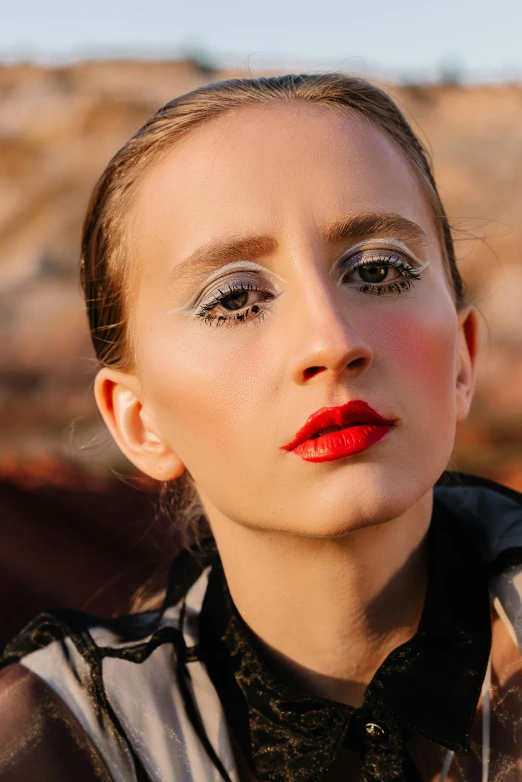 a model with bright red lipstick on the eyes and shirt