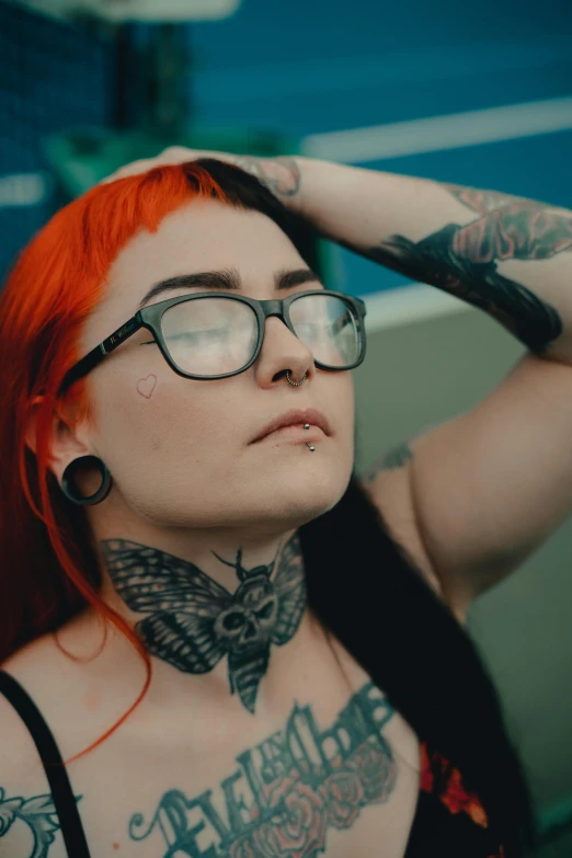 a red haired woman with tattoos and piercings