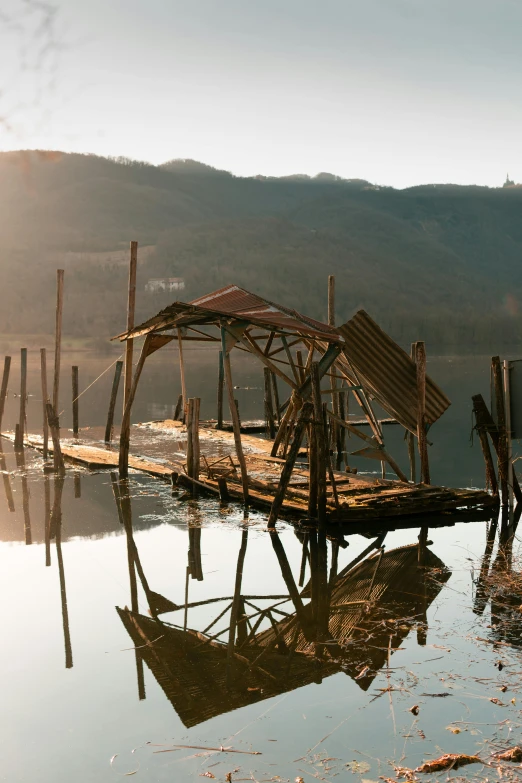 a rustic building sitting on the shore near water