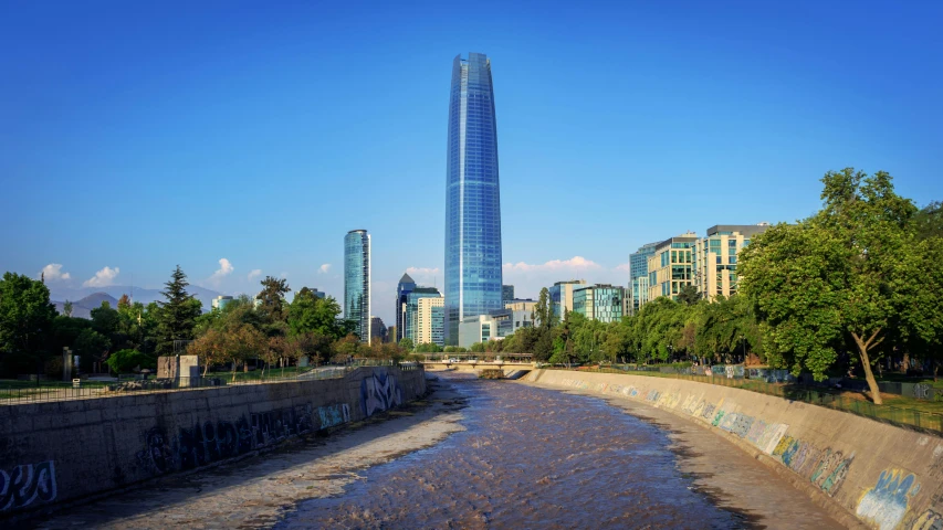 some very tall buildings by a waterway