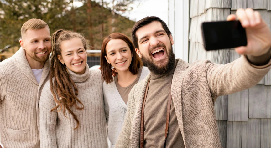 a woman and two men taking pictures