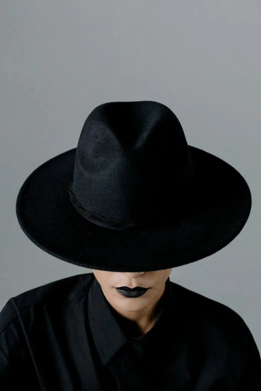 a person wearing a black shirt and a black hat