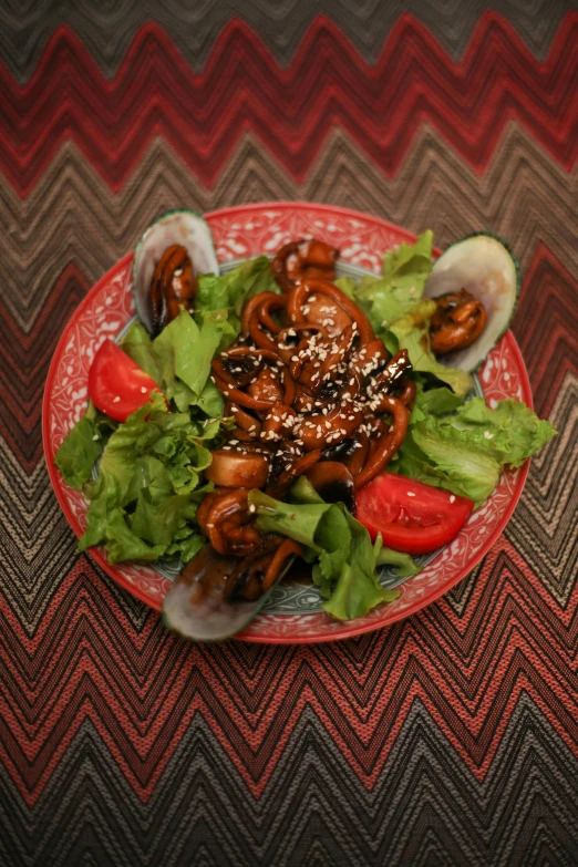 a colorful dish has mushrooms, lettuce, tomatoes and onion