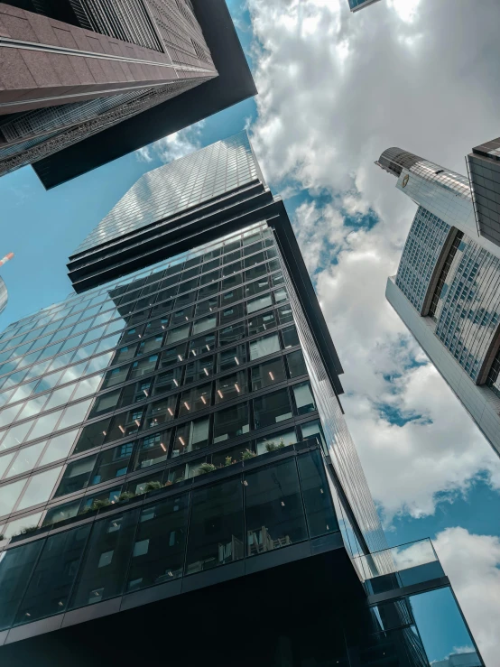 four office buildings against the sky and clouds