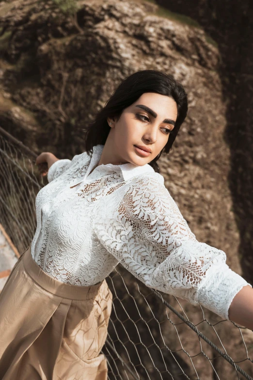 a woman posing in front of a mountain