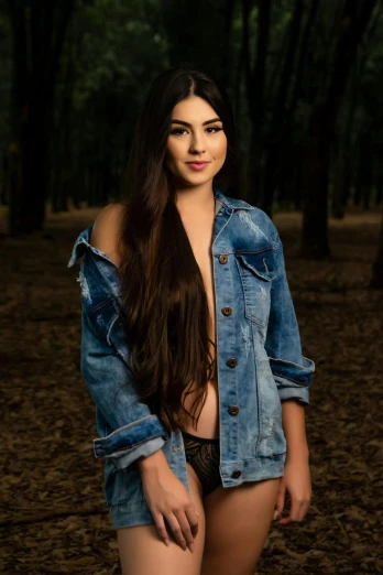 young  woman in jeans jacket posing outdoors