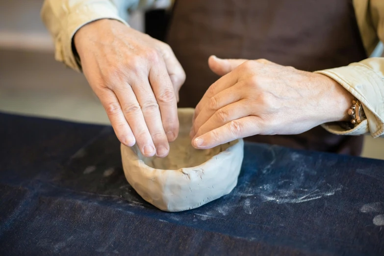 someone is kneading dough on top of a table