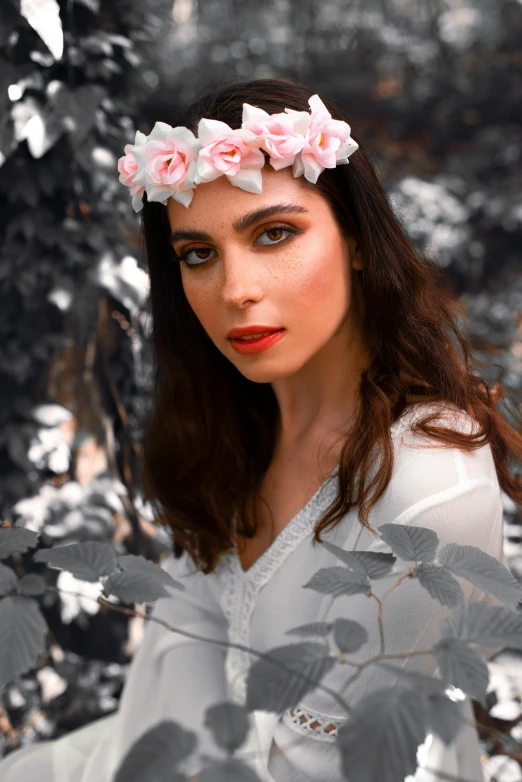 a woman posing for the camera wearing a flower crown