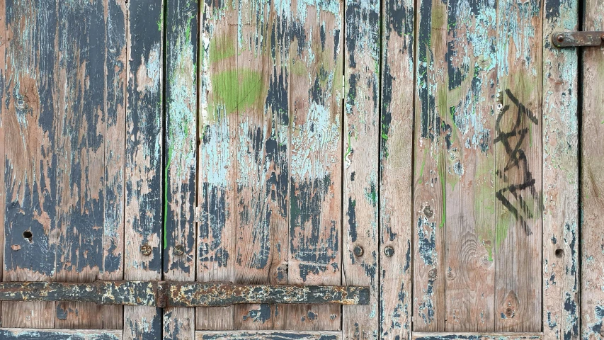 there is some blue paint on the side of a wooden door