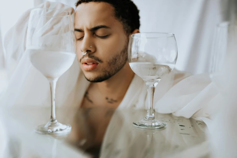 a man with wine glasses and a towel on the back