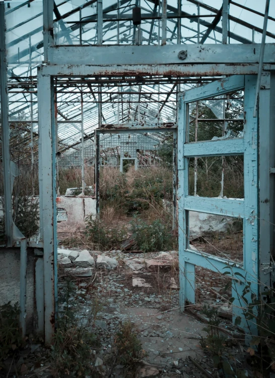 an old run down building with windows and a wooden door