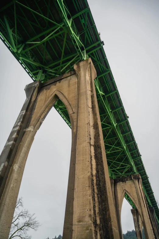 the underside of a bridge with scaffolding in an urban area