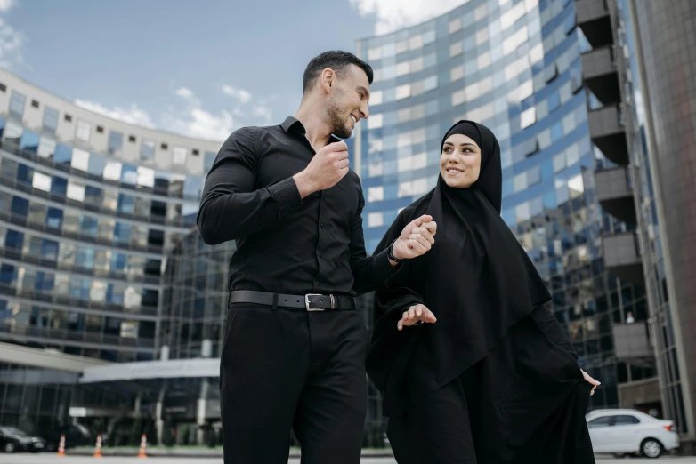 a couple is walking along in the middle of the road