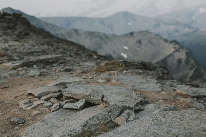 some rocks and sand on top of the mountain