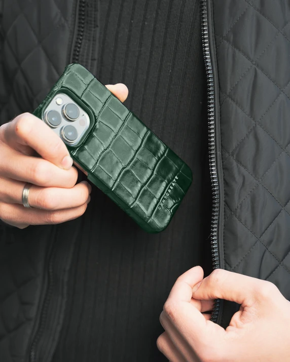 a woman holding a green case and cell phone