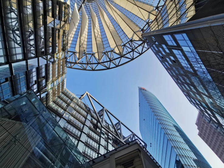 looking up into the glass fronted structure of buildings in downtown vancouver