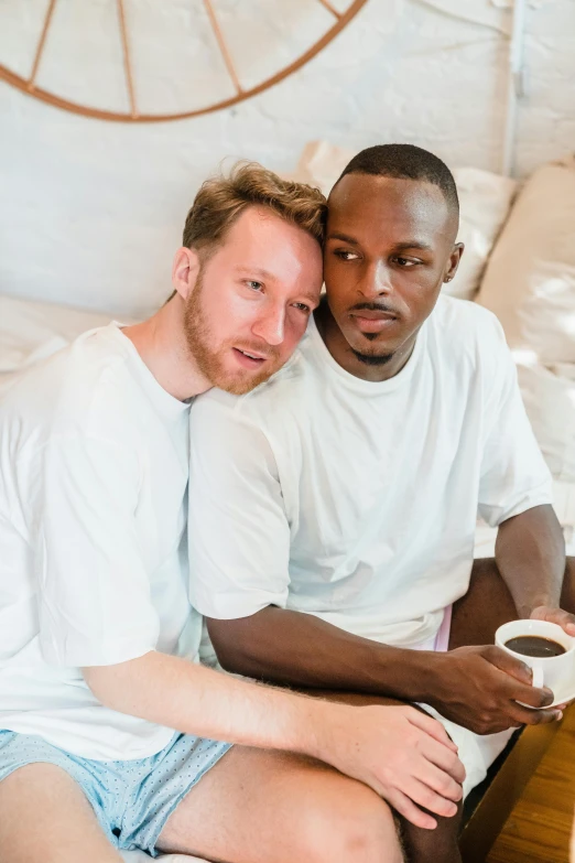 the two young men are sitting in their underwear