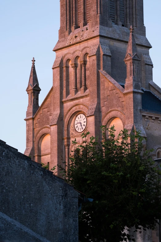 a large clock tower sits in the center of a city