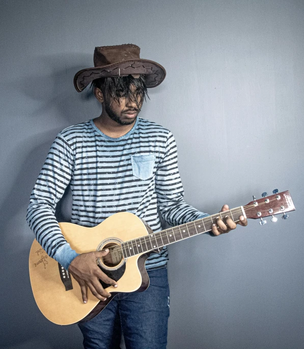 a man with a hat and guitar