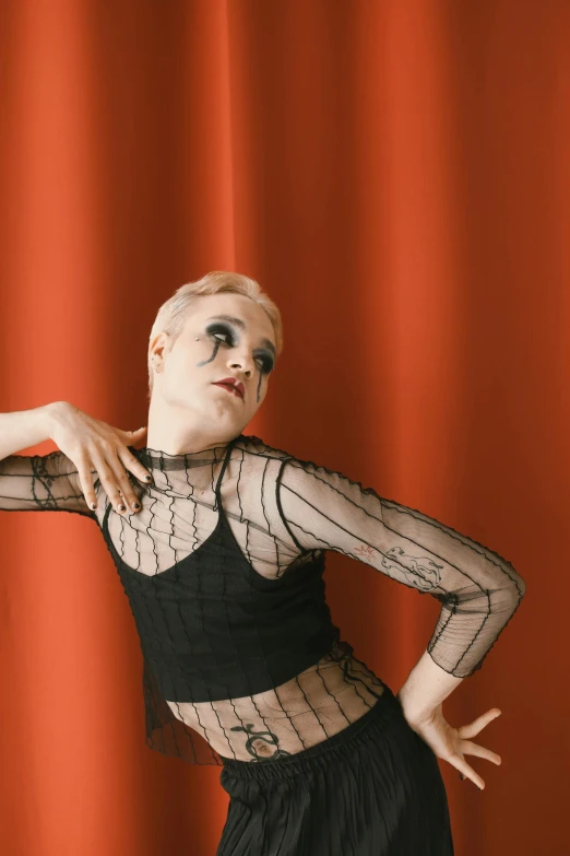 the woman with painted eyebrows is posing in a black shirt