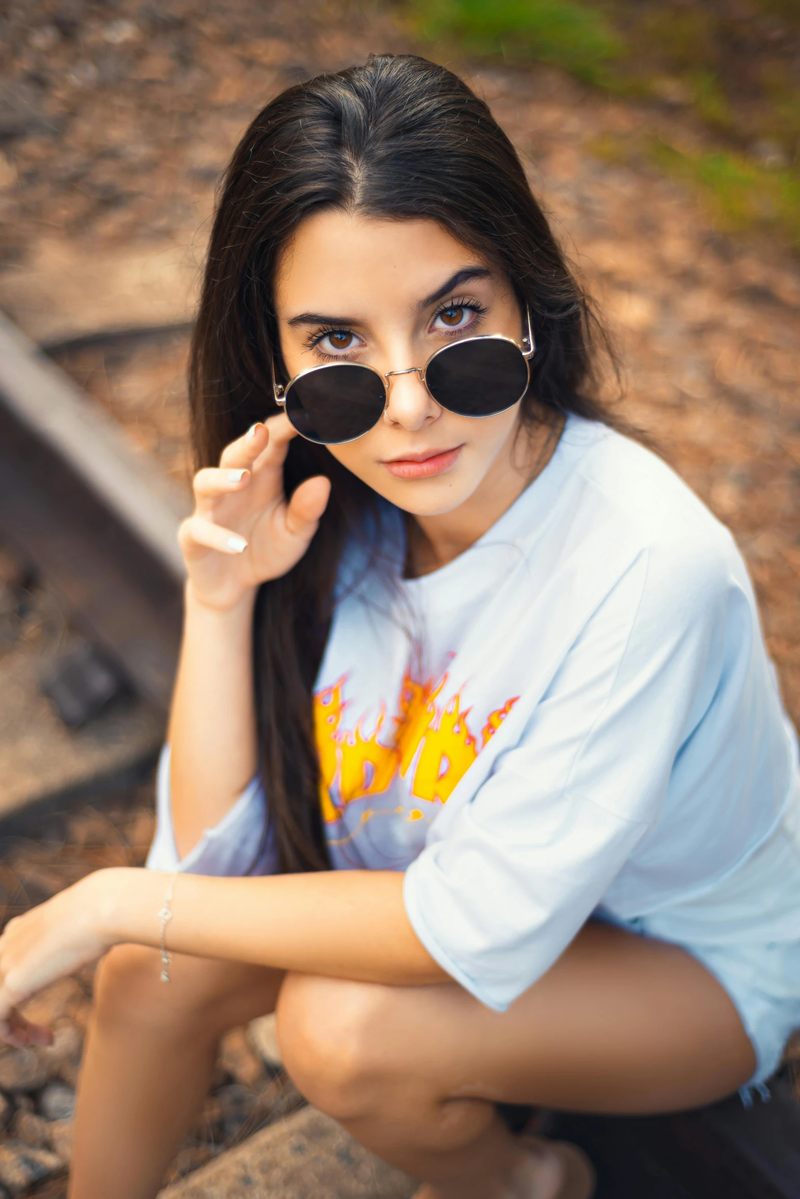 a pretty  sitting on the edge of a rail