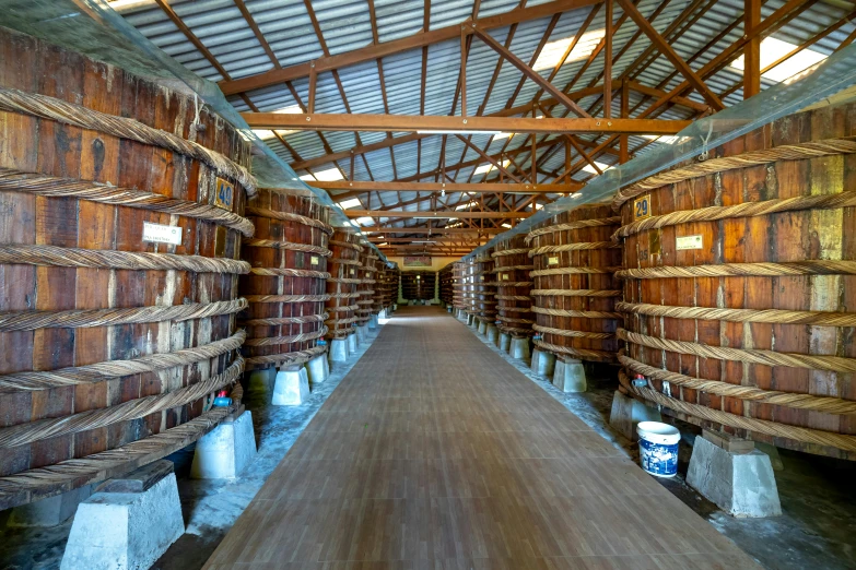 wooden barrels in a warehouse next to walls