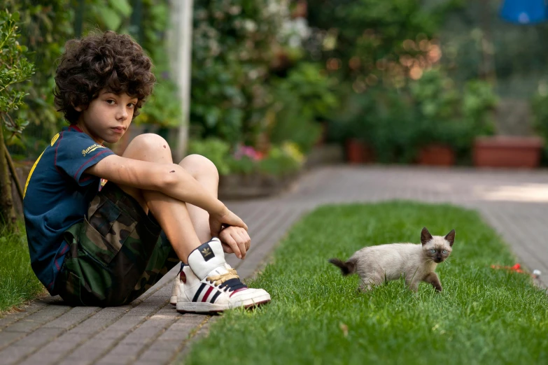 there is a small animal in the grass and there are a little boy
