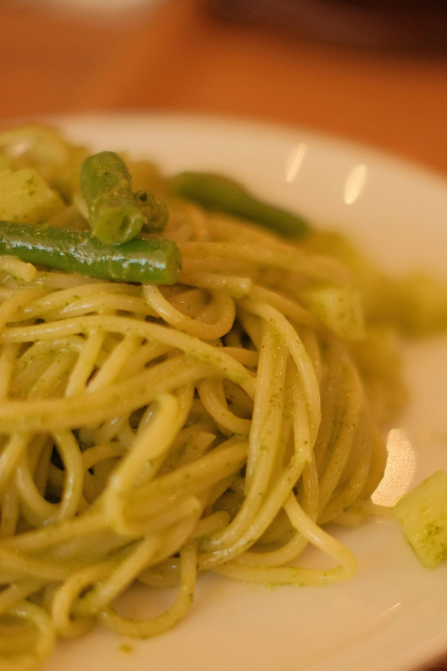 closeup on a plate of noodles and green peppers