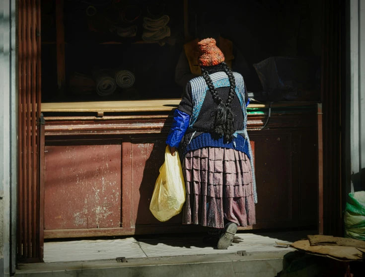 a woman with her handbag and other items at a shop