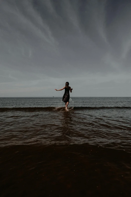 a person in the water with their arms out