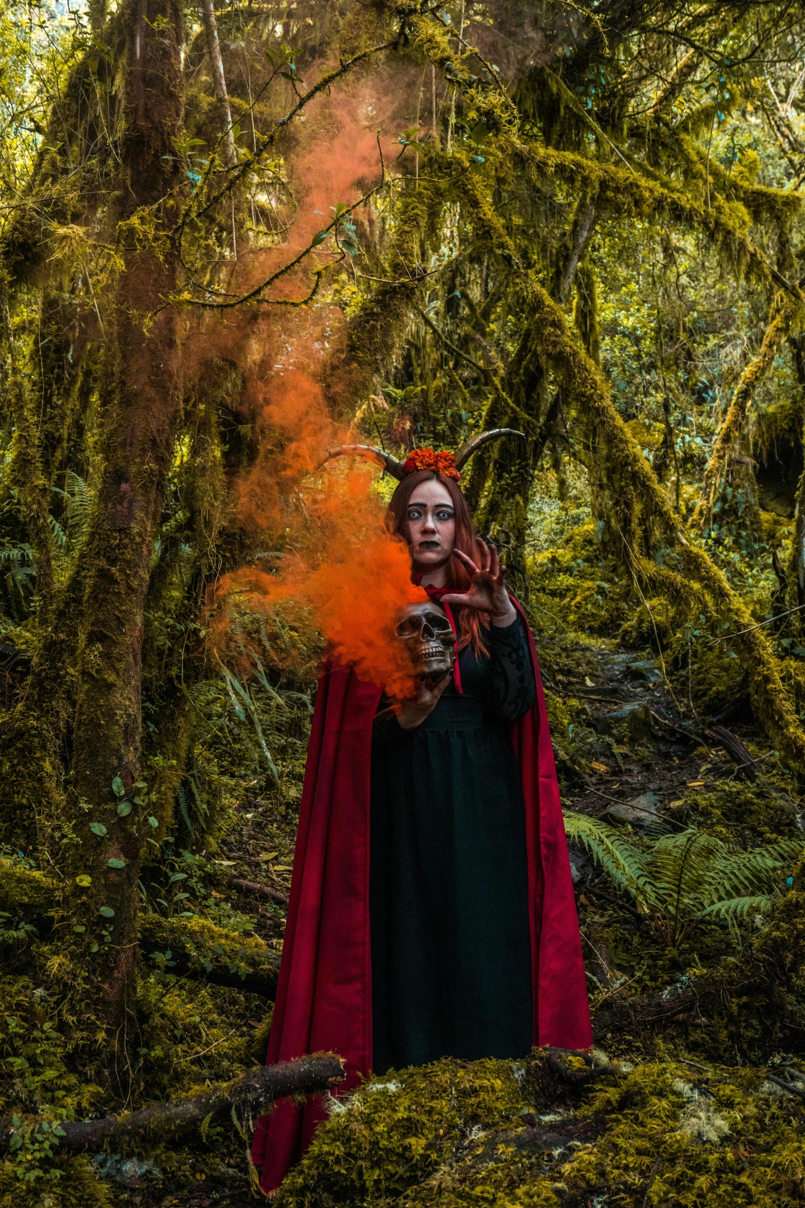 a woman wearing red and black in a forest