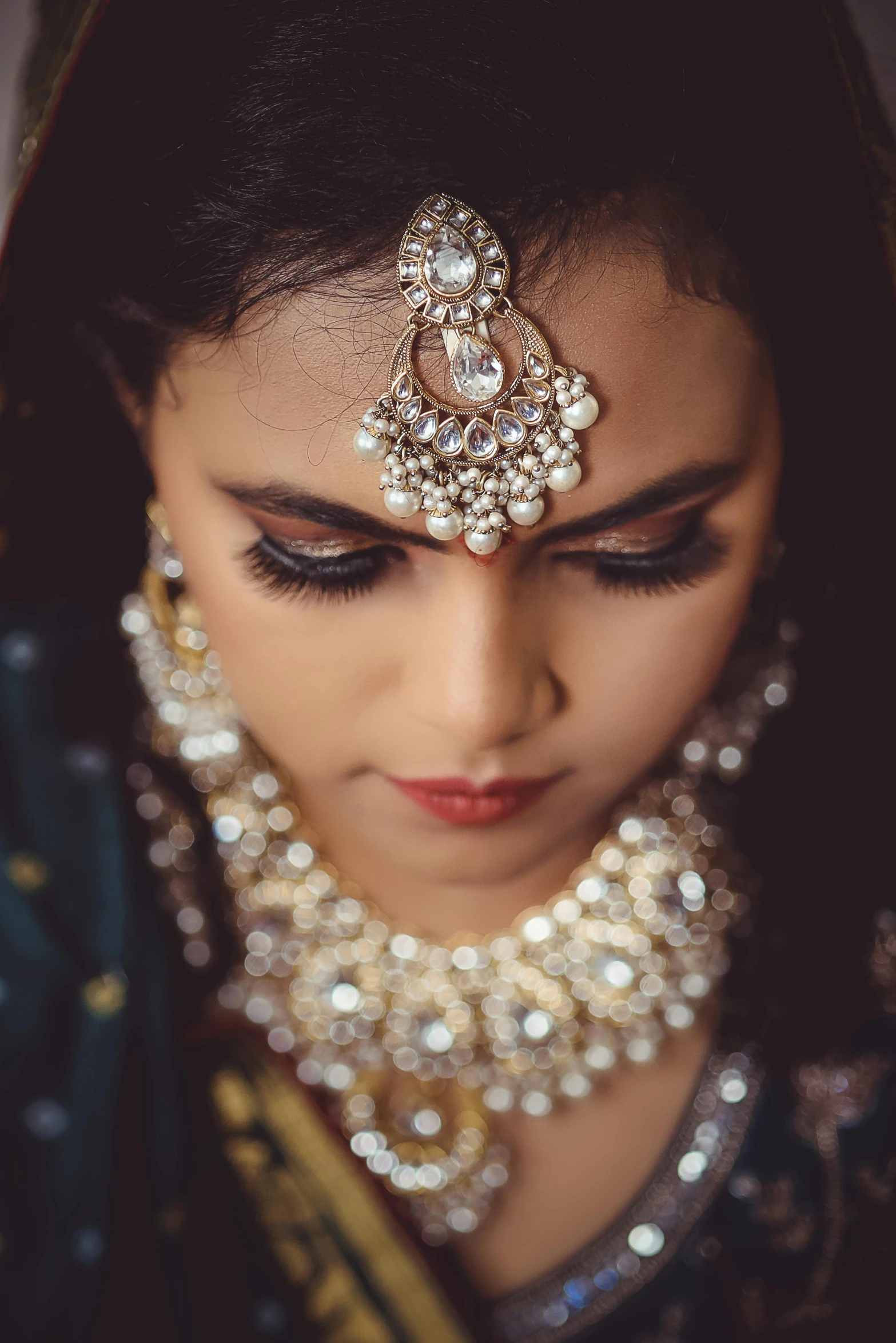 the head of a woman wearing a diamond jewelry