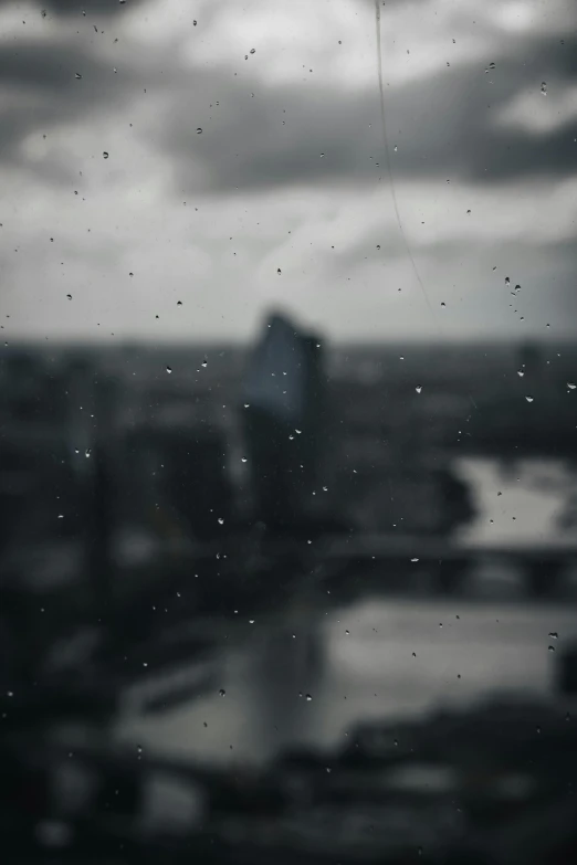 an aerial view of a city with rain and a kite