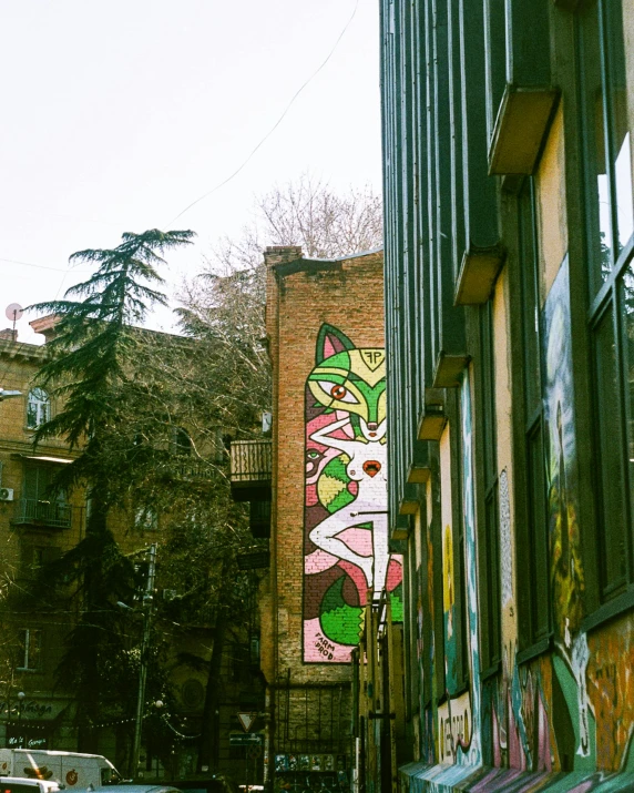 street scene with a mural on the side of a building