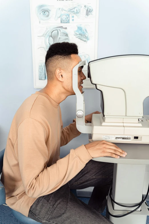 a person sitting in a chair using an eye chart