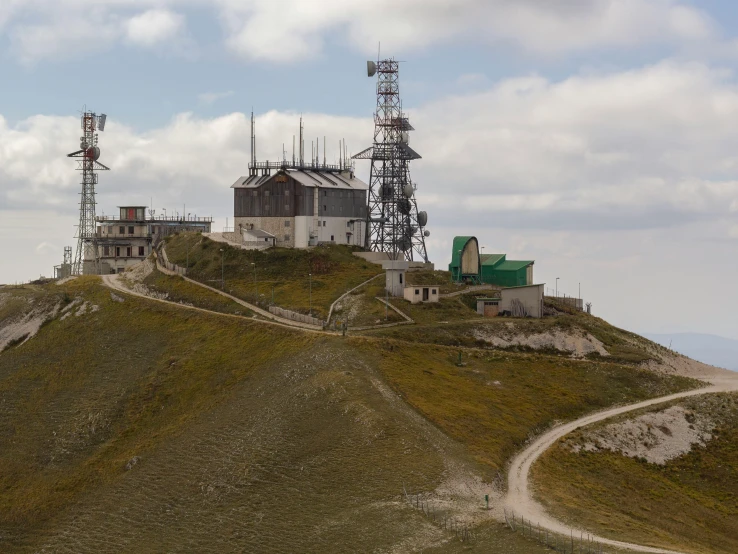 a hill with an old structure that is in the middle