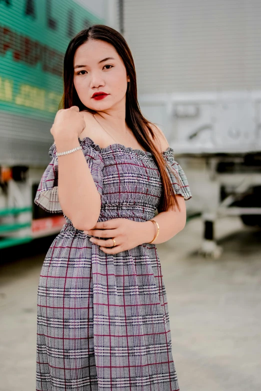 young asian woman in an off the shoulder dress, wearing a watch