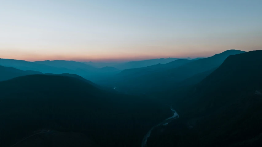 sunset over mountains, with blue light at the top