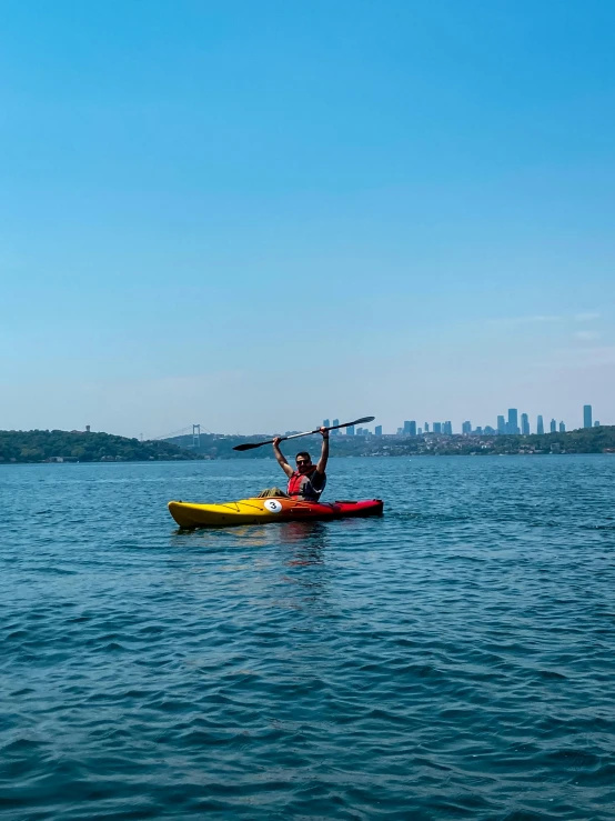 there is a man on a yellow canoe