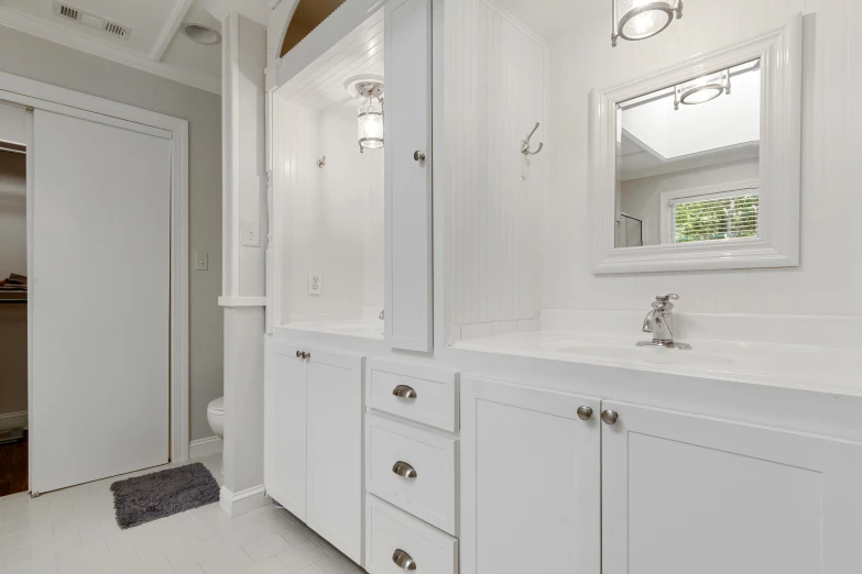 the interior of a bathroom with white fixtures