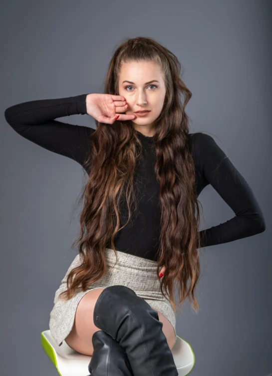 a woman with long hair sitting in a chair