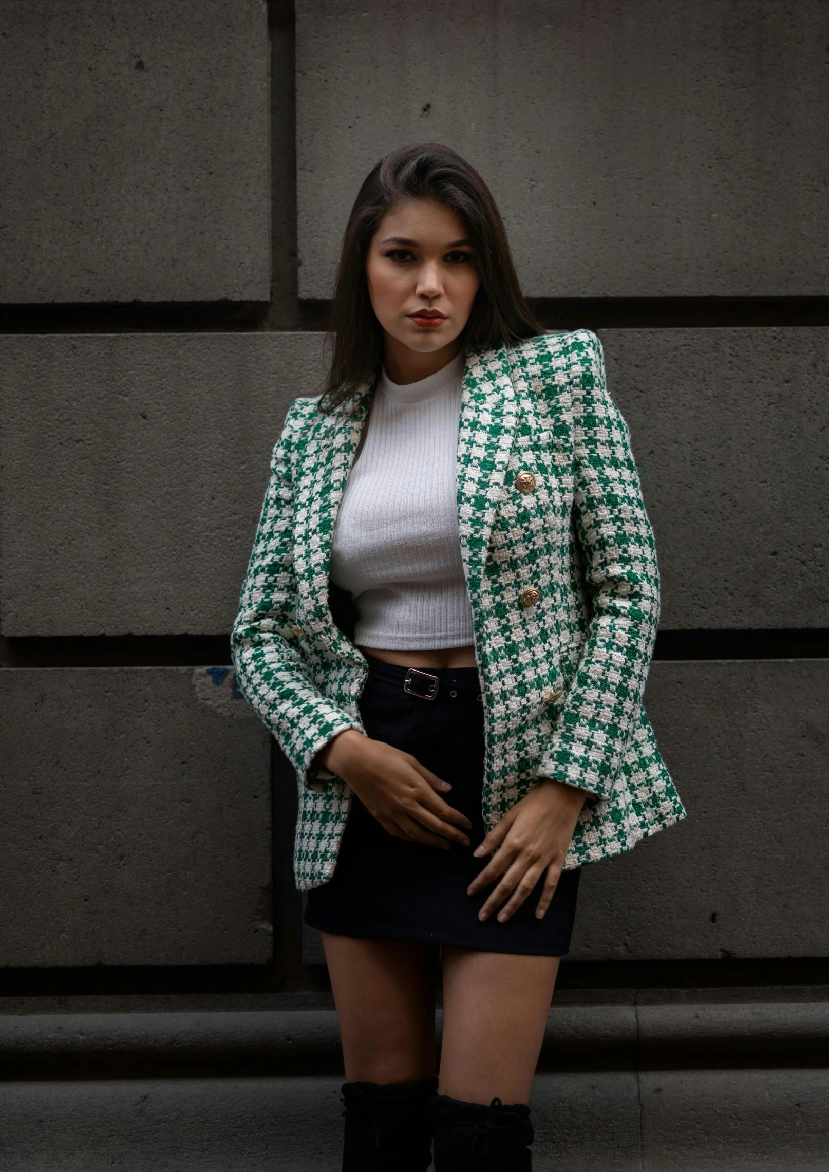 a woman in green and white jacket posing for a picture