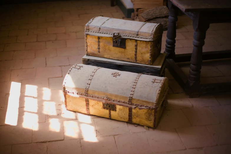 two chests stacked next to each other on a floor