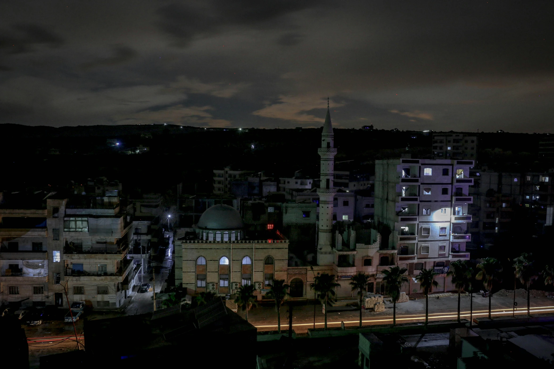 a city with a lot of lights and dark sky