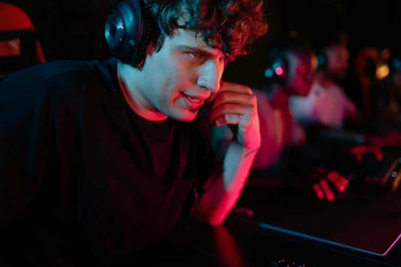 young man playing a game with a large gaming mouse