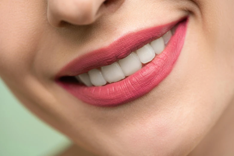 a woman's mouth and white teeth are close up