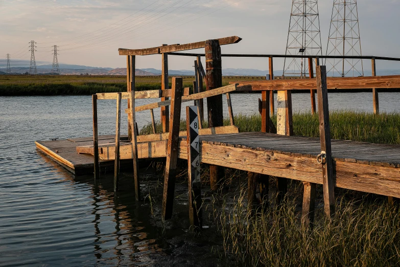 a dock in the water with birds flying over it